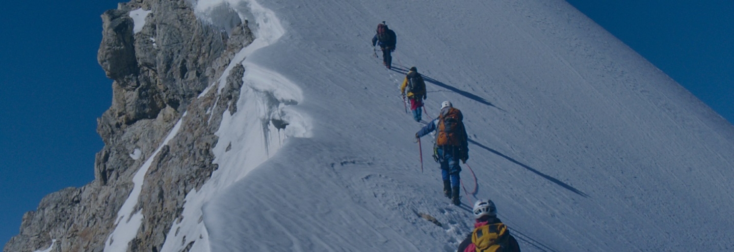 Mountain climbers scaling a snowy peak